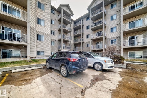 Multi-story residential building featuring horizontal siding and multiple private balconies with white railings - 317 7511 171 Street, Edmonton, AB - Outdoor With Balcony