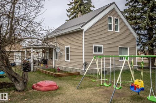 Gable-front house with tan horizontal siding and a dark metal roof - 5213 49 Ave, St. Paul Town, AB - Outdoor