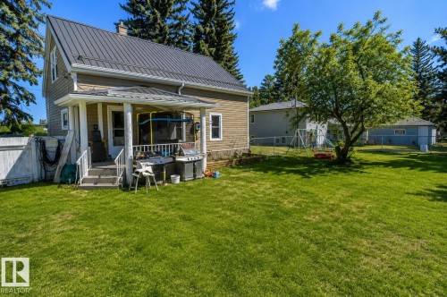 Rear exterior with metal roof and covered porch - 5213 49 Ave, St. Paul Town, AB - Outdoor