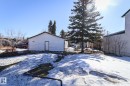 Detached outbuilding with white siding and a single entry door - 4114 Main Street, Ashmont, AB  - Outdoor 