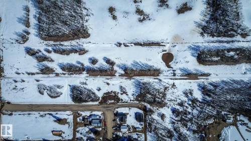 Aerial perspective showcasing snow-covered ground with visible dirt pathways - Sw-34-59-12-4, Spedden, AB 