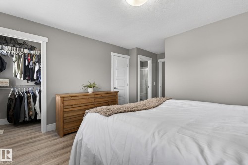 Bedroom featuring light gray walls, wood-finish flooring, and white trim - 2017 Westerra Loop, Stony Plain, AB - Indoor Photo Showing Bedroom