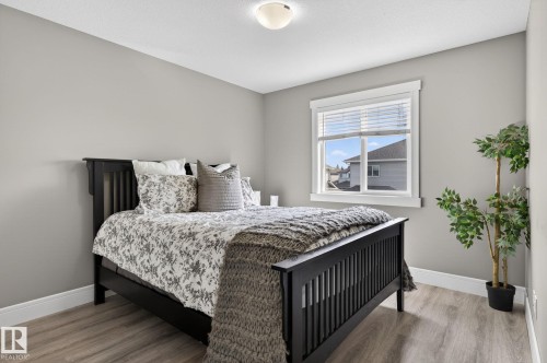 Room featuring neutral gray walls and wood-finish flooring - 2017 Westerra Loop, Stony Plain, AB - Indoor Photo Showing Bedroom