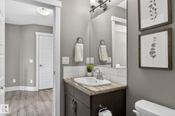 Vanity with wood-finish countertop, undermount sink, and chrome faucet - 