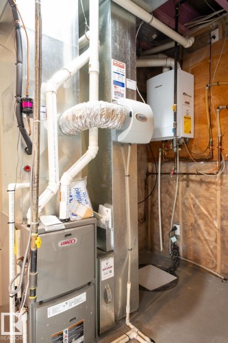 Dedicated utility area featuring a Lennox furnace, a tankless water heater, and a whole-home humidifier - 2017 Westerra Loop, Stony Plain, AB - Indoor Photo Showing Basement