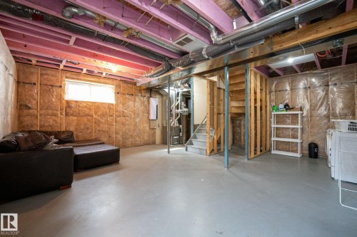 Unfinished basement featuring exposed joists, insulated walls, concrete flooring, and a window providing natural light - 2017 Westerra Loop, Stony Plain, AB - Indoor Photo Showing Basement