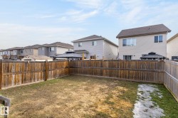 Private backyard space featuring a wood fence enclosure - 