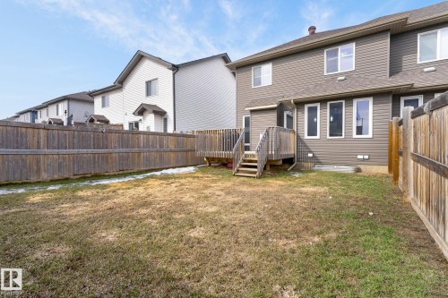 Spacious backyard featuring a wood deck with stairs, surrounded by a wooden privacy fence - 2017 Westerra Loop, Stony Plain, AB - Outdoor