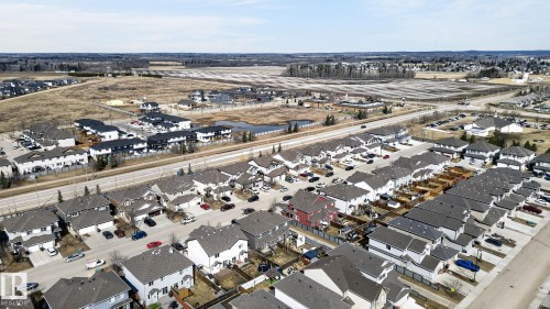 Aerial perspective showcasing a residential development with a mix of single-family homes and multi-unit buildings - 2017 Westerra Loop, Stony Plain, AB - Outdoor With View