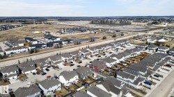 Aerial perspective showcasing a residential development with a mix of single-family homes and multi-unit buildings - 