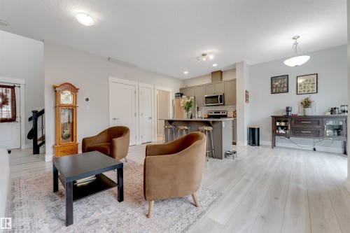 Open-concept living space featuring light wood-finish flooring throughout - 11 4835 Wright Drive, Edmonton, AB - Indoor Photo Showing Living Room