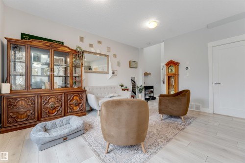 Bright interior space featuring light-toned flooring, white walls, and a white ceiling with a flush-mount light fixture - 11 4835 Wright Drive, Edmonton, AB - Indoor