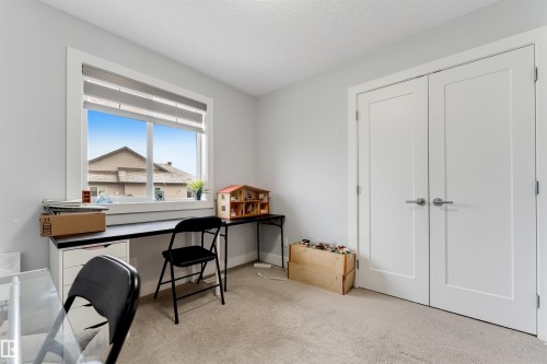 Room with light gray walls, white trim, and light-colored carpeting - 11 4835 Wright Drive, Edmonton, AB - Indoor