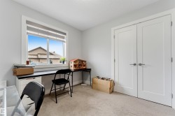 Room with light gray walls, white trim, and light-colored carpeting - 