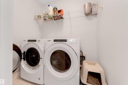 Dedicated laundry area featuring a front-loading washer and dryer set - 