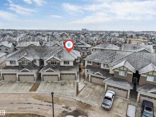 The property, marked by a house icon, is a two-story residence featuring a two-car garage - 11 4835 Wright Drive, Edmonton, AB - Outdoor With Facade