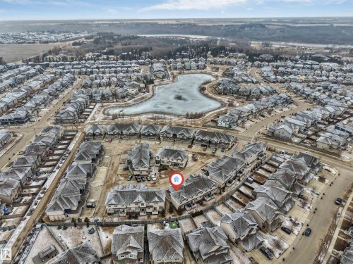 Aerial view of the community, featuring residential properties and a central pond - 11 4835 Wright Drive, Edmonton, AB - Outdoor With View