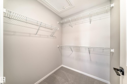 The property features a spacious closet with wire shelving, light grey walls, and carpeted flooring - 840 Stillwater Boulevard, Edmonton, AB - Indoor With Storage