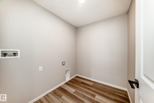 Utility room featuring wood-style flooring and light-colored walls - 840 Stillwater Boulevard, Edmonton, AB - Indoor Photo Showing Other Room