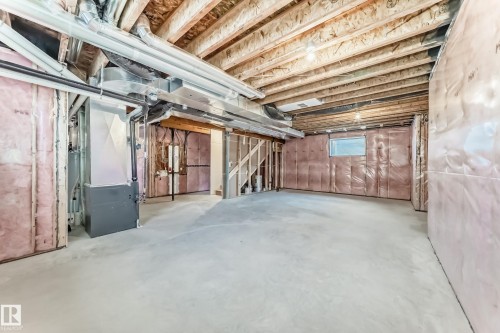 The property features an unfinished basement with exposed wooden joists, concrete flooring, and insulated walls - 840 Stillwater Boulevard, Edmonton, AB - Indoor Photo Showing Basement