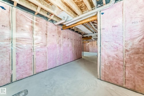 The property features an unfinished basement with exposed wooden joists and insulated walls - 840 Stillwater Boulevard, Edmonton, AB - Indoor Photo Showing Basement
