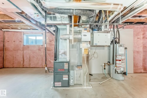 The property features an unfinished basement with a concrete floor, a window, and exposed ceiling joists and ductwork - 840 Stillwater Boulevard, Edmonton, AB - Indoor Photo Showing Basement