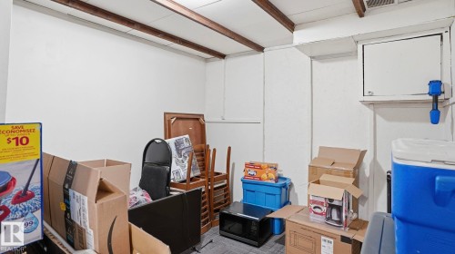 Room featuring exposed wood ceiling beams and white painted walls - 12 14120 80 Street, Edmonton, AB - Indoor