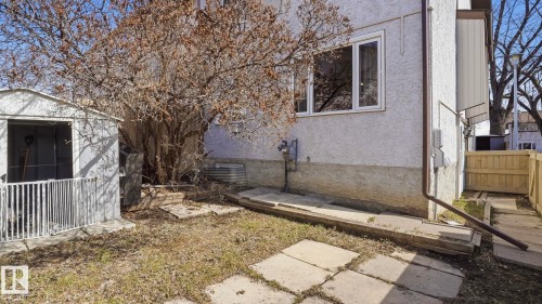 Compact backyard featuring a white storage shed and concrete stepping stones - 12 14120 80 Street, Edmonton, AB - Outdoor