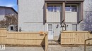 Light stucco exterior with vertical accent siding and two upper-level windows - 12 14120 80 Street, Edmonton, AB  - Outdoor With Exterior 
