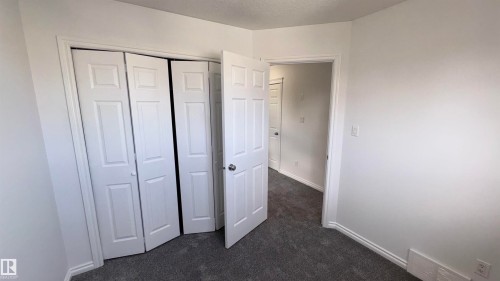 This room features neutral-toned walls, grey carpeting, and white trim - 10231 163 Street, Edmonton, AB - Indoor Photo Showing Other Room