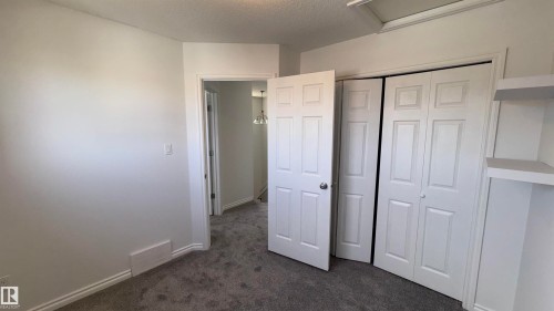 The property features white walls, carpeted flooring, and white trim - 10231 163 Street, Edmonton, AB - Indoor Photo Showing Other Room