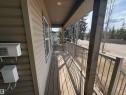 The property features a covered porch with a wooden deck and metal railings - 10231 163 Street, Edmonton, AB  - Outdoor With Exterior 