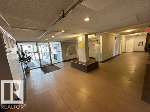 Lobby area featuring light-toned square floor tiling and recessed lighting - 86 13435 97 Street, Edmonton, AB - Indoor Photo Showing Other Room
