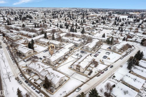 Aerial perspective showcasing a residential community with numerous townhome-style residences - 7 14115 82 Street, Edmonton, AB - 