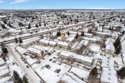 Aerial view showcasing a residential community with multiple townhouse complexes - 