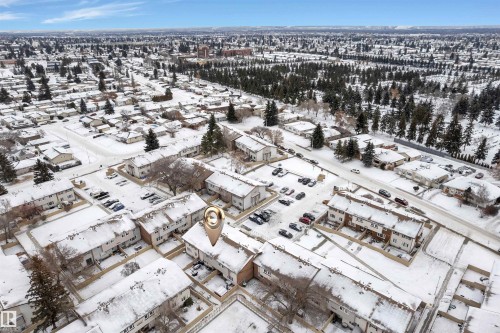 Aerial view of a residential area featuring multiple attached housing units with snow-covered roofs - 7 14115 82 Street, Edmonton, AB - Outdoor With View