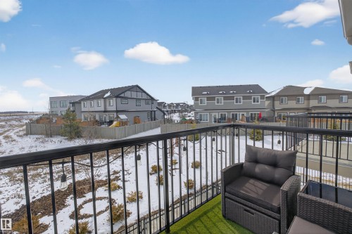 The property features a balcony with black metal railings and artificial turf flooring - 28 6214 Cartmell Crest, Edmonton, AB - Outdoor