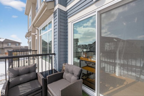 The property features a balcony with black metal railings and a sliding glass door - 28 6214 Cartmell Crest, Edmonton, AB - Outdoor