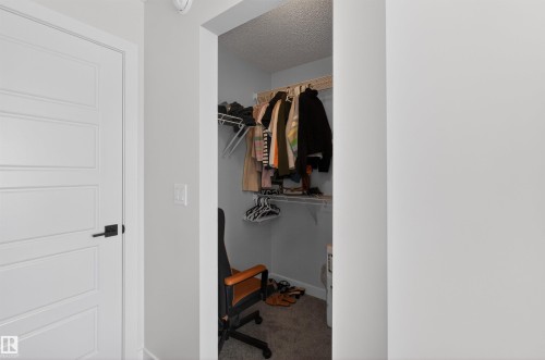 This closet features carpeted flooring and white wire shelving - 28 6214 Cartmell Crest, Edmonton, AB - Indoor