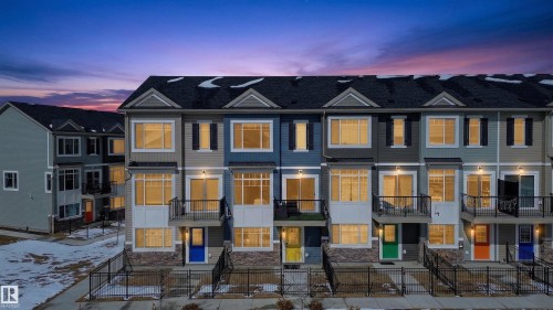 The property features a townhome style with a dark roof and light-colored siding - 28 6214 Cartmell Crest, Edmonton, AB - Outdoor With Facade