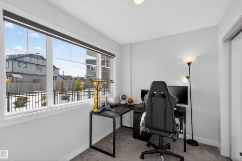 This room features neutral-toned walls and carpeted flooring - 28 6214 Cartmell Crest, Edmonton, AB - Indoor Photo Showing Office