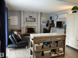 Central wood-finish island with a light-toned stone countertop, integrated drawers, and open shelving - 