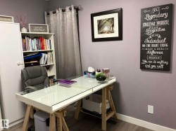 Recessed lighting and wood-finish flooring complement the neutral wall tones - 