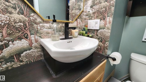 Bathroom vanity with a white vessel sink and a matte black faucet - 3531 46 Street, Edmonton, AB - Indoor Photo Showing Bathroom