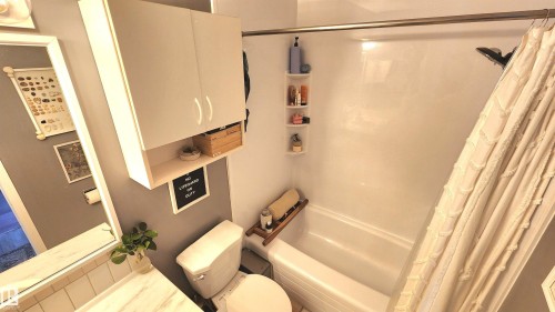 Full bathroom featuring a white tub and shower combination with a curved shower rod - 3531 46 Street, Edmonton, AB - Indoor Photo Showing Other Room