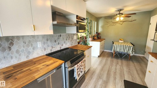 Kitchen featuring light wood-finish flooring and a ceiling fan - 3531 46 Street, Edmonton, AB - Indoor Photo Showing Kitchen