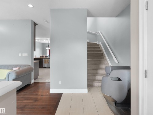 Interior staircase with carpeted treads and white handrails - 5192 1B Avenue Sw, Edmonton, AB - Indoor Photo Showing Other Room