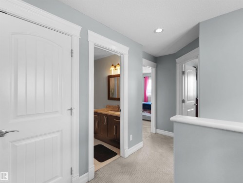 Hallway featuring light gray walls, carpeted flooring, and recessed ceiling lighting - 5192 1B Avenue Sw, Edmonton, AB - Indoor