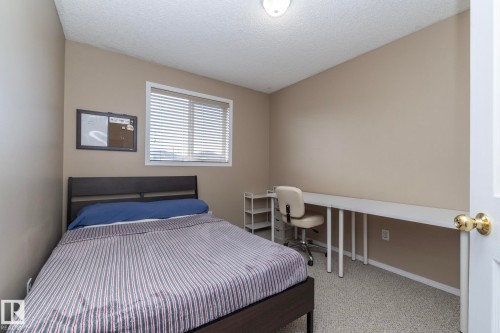 Neutral-toned room with light beige walls and light-colored carpeting - 50 14803 Miller Boulevard, Edmonton, AB - Indoor Photo Showing Bedroom