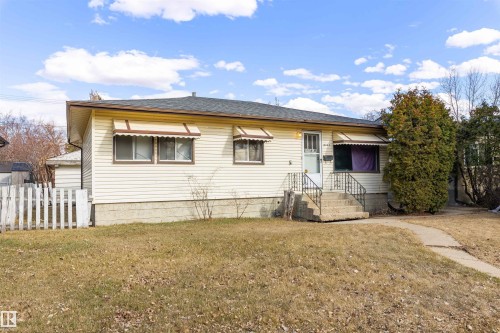 Light-colored siding exterior with a dark shingled roof - 9007 149 Street, Edmonton, AB - Outdoor